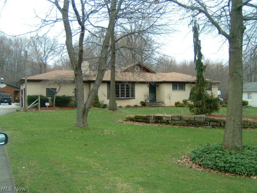 Country living, but close to everything! Brick Ranch w/3 BR's, 2 Ba's, 20x24 custom-built FR w/wood burner, tongue-in-groove, knotty pine, cathedral ceiling, textured plaster walls, oak wainscoting, poplar wood trim, sliding doors w/traverse windows, spiral staircase to 14x15 loft, recessed lighting, custom-designed ceiling fan for proper air circulation. Large LR w/wood burner, coved ceiling, brand-new bay window, newer carpeting. Beautiful 12x20 Kitchen w/custom designed maple cabinetry, as smooth as furniture, all appliances, granite counters, ceramic tile backsplash, built-in table/seating. Another built-in, cushioned seating area in the DR. Updated main bathroom. Rec room in the basement that is 11x30 with desk area. Second bathroom in the basement with a shower. Storage room. Utility room/laundry area in the basement. 40 gal., gas HWT (2009). A surprising 20x50 outbuilding/garage for vehicle/boat storage which is all finished w/wood burner, cable, knotty-pine ceiling, a porch and