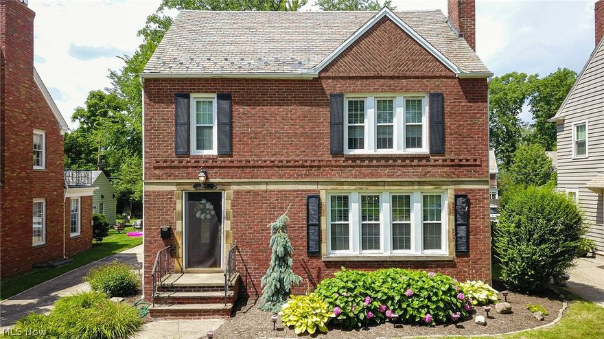 Charming 4/5 bedroom, 2.5 bath Brick colonial located in coveted JCU neighborhood. Exceptional, beautifully updated home balanced with traditional architectural detail. Wood floors, crisp trim and neutral color pallet make this classic home feel modern and fresh. A wood burning fireplace with traditional mantle and marble surround highlight the spacious living room. Entertaining is easy in the formal dining room with chair rail and built-in corner cabinets featuring glass display. The family will gather in the updated kitchen with convenient center island breakfast bar. Light cabinetry and bay window highlight this bright space. Located off the dining room is a sunroom/den with slider to the expansive back yard and 2 level deck. A convenient half bath adds to the first floor. The fabulous full bath restoration with classic details and modern amenities is the highlight of the second floor along with 3 bedrooms and continued wood floors. The 3rd floor offers 2 more bedrooms and a 2nd upd