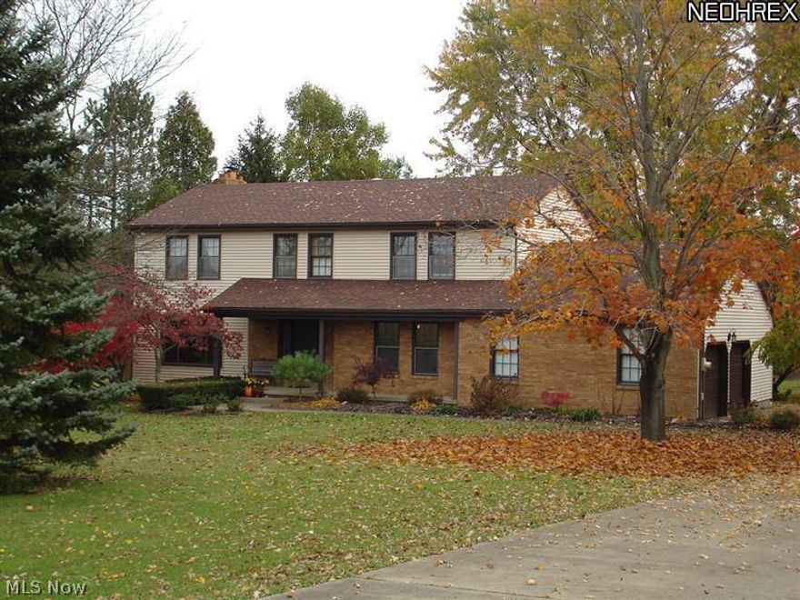 Quiet country living in the South Range School District is this beautiful 4 bedroom, 2 1/2 bath, 2 story home settled on 2.3 acres of property w/wooded views from the 3 level deck, one level which is covered.  Newer kitchen w/granite counter tops and tiled backsplash and hickory hardwood flooring.  Great room has a stoned wall woodburning fireplace w/oak hardwood flooring.  Features an all season room overlooking backyard and oak hardwood flooring, living room, dining room and first floor laundry.  Master bedroom has 6 x 5 sitting area w/walk in closet and window seat, master bath and 2 extra closets.  partially finished basement.  This home offers plenty of storage.  Roof and siding are 2004/2005 and furnace 5 years old. Newer heat pump is 2 years old.  Nice size outbuilding, 3 car garage and much more.  A must see!!
