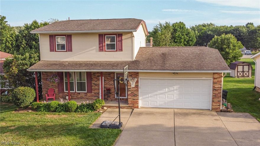 Here is a great two-story brick and vinyl-sided home in this desirable Perry township location with a quick drive to the highway and it has so much to offer! The extra wide concrete driveway with an extra pad is in great shape and leads to the eye-catching covered front porch surrounded by awesome well-manicured landscaping. There's a large garden shed in this fantastic backyard, complete with a deck, vegetable garden, and fire pit.  The layout is terrific with an inviting foyer and opens to the large living room with new carpet. The kitchen offers plenty of quality oak cabinets, lots of counter space including an island, stainless steel appliances, and tile backsplash; it truly is the heart and center of this home. There's a formal dining room and also a family room with sliding glass doors to the deck. The enormous master bedroom with a walk-in closet will fit almost any size bedroom set. The bath and a half are in great shape.  The basement offers 2 excellent finished rooms and a la