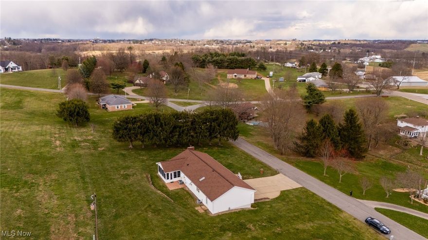 WOW! This large four-bedroom, four-bath home has almost 3000 sq.ft. All on one floor, there is room for everything! Located just five minutes from I-70, this house is convenient to shopping, schools, and Wheeling, WV, which is a quick 15-minute drive. The original house was built in 1972 but in 1992 it was added onto and remodeled. You are going to love the HUGE built-on primary bedroom with over 500sq.ft.! Added on also is the large primary bathroom with a built-in laundry. There are FOUR double closets in this massive room also! your own winter and summer closets right there! There is a large laundry room in the basement with a full bath. 2 washers and dryers are included. The eat-in kitchen has a nice island and area for a kitchen table. Off of the kitchen is an enclosed glassed-in sun room that opens to the large backyard. There is an oversized 3 car garage with extra flex space for a shop/boat/4 wheelers etc. with its own mandoor. The carpets were professionally cleaned on 3/22/25 . The house was also professionally cleaned at the same time. This house is in move-in condition and waiting for its new family!