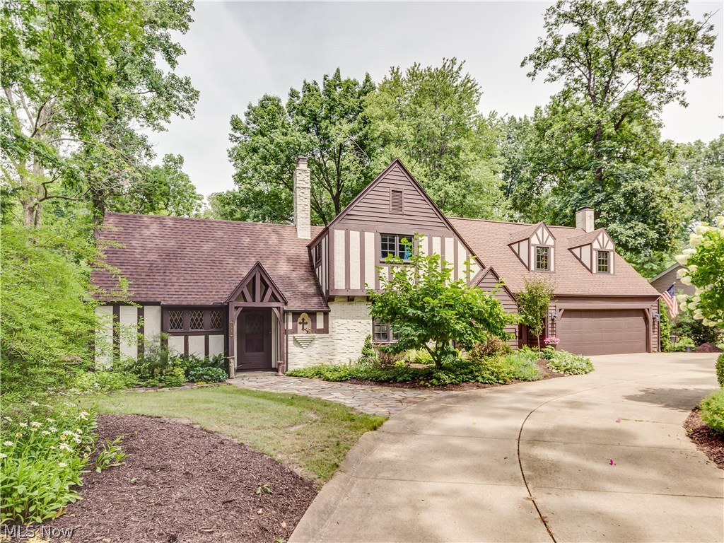 Prepared to be amazed by this spectacular Tudor style home in Silver Lake Estates with a desirable location on a 1/2 acre lot situated between Silver Lake and Crystal Lake. Truly a one of a kind masterpiece where quality & charm abounds. The foyer entrance leads to the living room/kitchen addition with wood beamed ceiling, ash wood floors, hickory cabinets, granite counters and updated appliances. There's a separate entrance to the dramatic and impressive open and spacious great room which has a soaring cathedral beamed ceiling , beautiful wood floors and a gas/wood fireplace. Formal dinning room with hickory floors, cozy office or den, impressive craft room plus 1/2 bath completes the first floor. Just a few steps leads up the private master suite with vaulted ceilings, his and her closets and beautifully updated master bathroom. The second floor has two guest bedrooms a full bath plus a second family room with a gas fireplace. The lower level has a fourth bedroom or office plus a