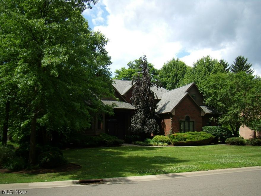 This well-built home is nestled on a wooded lot with golf course view.  Offering 4,250 total sqft, 4-5 BRs, 3 full & 2 half baths.
July, 2014 updates include kitchen island granite, light fixtures & faucets, and wallpaper removal/paint/carpet. Two-story foyer opens to formal dining room & dramatic two-story great room with floor-to-ceiling windows & fireplace. Convenient first floor study with built-ins. Bright kitchen has abundant cabinet space, hardwood floors, large island with new granite countertop. First floor master bedroom & bath with huge walk-in closet. Spacious secondary bedrooms including 20’ x 13’ fifth BR or bonus room. Finished lower level has recreation room with built-ins, large wet-bar, bonus room & half bath. Beautiful large patio with fantastic privacy landscaping. This is a lot of house for the price!!