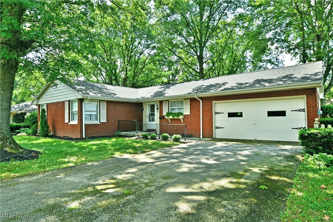 This brick ranch in Canfield is ready for you! Welcome to 225 Sleepy Hollow Drive! As you step inside, original hardwood floors gleam underfoot and natural light fills the open concept living and dining areas. A corner fireplace sets the mood in the living room, complete with updated gas logs. The dining room provides french door access to the cheery sunroom patio, and backyard which is perfect for relaxation. Adjacent to the dining room is the kitchen with updated cabinetry, pantry storage and included appliances. Opposite the living spaces, three bedrooms showcase ample closet space along with original hardwood flooring. The main bath has been refreshed with a convenient low entry shower and new toilet. The lower level plays host to a large family room with built in storage and beautiful wood burning fireplace. Just beyond is another large room which is perfect for a home office, home gym, additional storage, whatever you can think of! A second full bath is just next to this space. Rounding out this level is the mechanical room which provides additional laundry hook ups and walk out access. What are you waiting for? Call today for your personal tour! **Updates: Roof 2020, Gutters & Downspouts 2020, French Drains 2020, Basement Walkout Rebuilt 2020, Front Porch and Sidewalk Replaced 2020, Gas Logs - Chimney Cap - Chimney Crown Reseal 2020.**