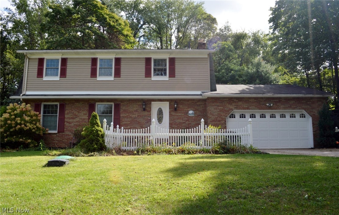 Move in ready.! Enjoy the holidays in this lovely Colonial in scenic Wonderland Hills of Jackson Township. The professionally landscaped lot provides a great setting for your family home. Relax on the rear patio and enjoy the sound of the water falls that is includes in the surrounding beds. An enclosed porch is also available for entertaining. There are many improvements done to the home such as a lovely updated kitchen with white cabinets, a granite top island, newer counter top, hardwood flooring, and newer appliances. The half bath has newer cabinets and granite top. The first floor family room with fireplace and beamed ceiling makes for a cozy room for family gatherings. The living room also has a decorative fireplace to accent the room. You will enjoy the spacious master bedroom with its own separate seating area. The lower level has a large recreation room for additional space for entertaining and there is a fitness room or office with bookcases and laminate flooring.