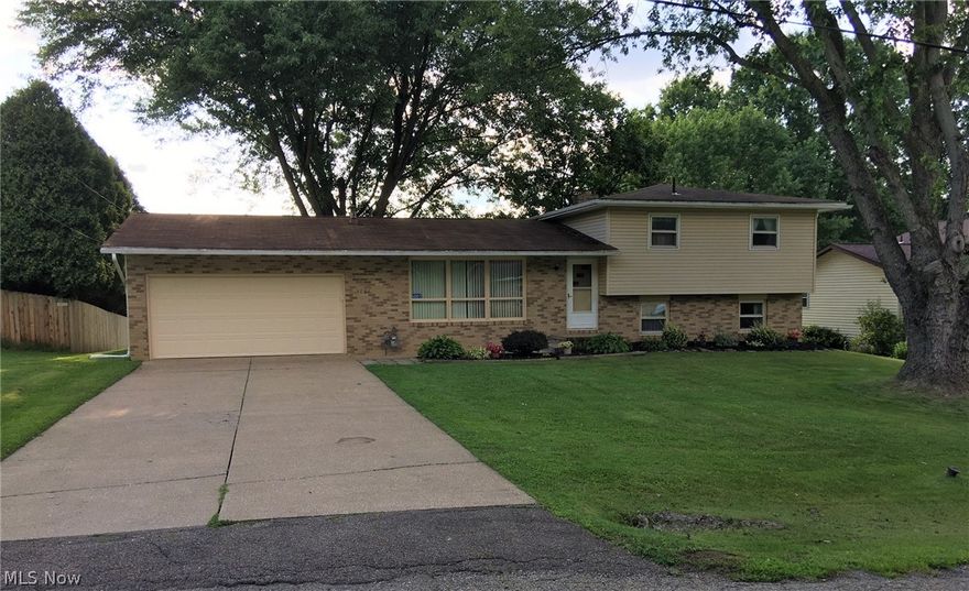 Desirable Perry neighborhood, a lovely 4 bedrooms 2 baths split level. This home has been well cared for by the present owner for nearly 50 years (they had the home built in 1972). Walk in the front door on the main level to a spacious living room with beautiful oak hardwood flooring. The kitchen (remodeled around 10 years ago) with a nice sized dining area, complete the main level. The upper level has the master bedroom and 2 additional nice sized bedrooms and a full bath. The same oak hardwood flooring in the living room is waiting to be uncovered, presently covered by existing carpet in the upper level’s bedrooms and hallway. The lower level has a large family room with a gas brick fireplace, the 4th bedroom and another full bath. The basement is spacious and houses the laundry and utilities. It is a walkout onto a nice patio with a large partially fenced back yard. It has an attached 2 car garage with a new garage door and opener with keypad (2021) recently installed. The home has