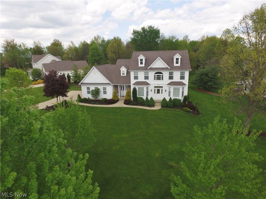 Stunning colonial in beautiful Westbridge Crossing! Open floor plan boasts over 2800 square feet of bright and inviting living space! Soaring two story foyer with hardwood flooring welcomes you home and leads to a formal living room and dining room with hardwood flooring. The Dining Room also features elegant crown moldings and wainscoting. Family Room with corner gas fireplace opens to the fully applianced, eat-in kitchen. Kitchen features a huge center island, granite counters, maple cabinets and hardwood flooring. Convenient desk area makes a perfect planning center.
Private, sunken, first floor office with french doors and a cozy gas fireplace! Wonderful mud/laundry room opens to both the garage and the covered porch. Upstairs you will discover a huge Master Suite with a fabulous view of the private backyard!  Master suite includes a huge full bath w/double vanity, garden tub and shower plus a large walk-in closet. Additional wall closet makes for extra storage! Three spacious bed