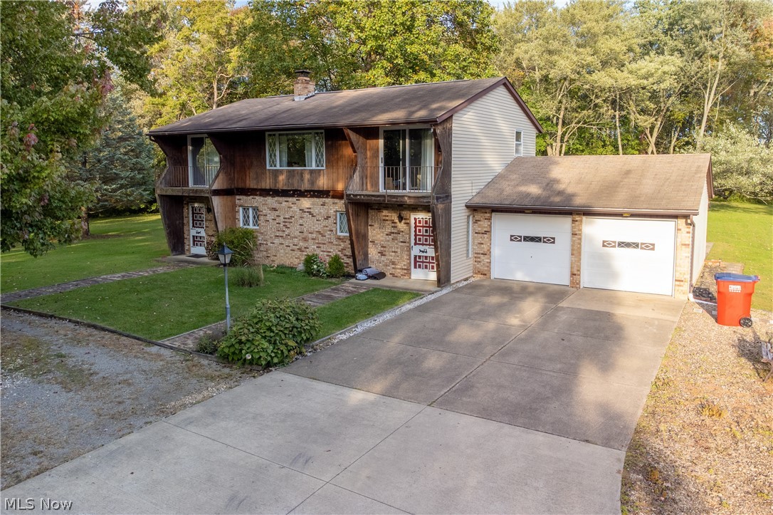 A wonderful home with tons of potential on over 3 acres in the heart of Nimishillen Township / Louisville School District. This home has so much to offer. Not only does it sit on 3 beautiful parcels, you have great possibilities inside for an additional living suite! Step into a nice sized living room with gorgeous fireplace! Den and kitchenette along with laundry and bath on first floor. Upstairs you will find another living room, kitchen, bathroom and 2 bedrooms, one is a master suite with master bath! Attached garage is huge with loads of storage. Outbuilding is perfect for all your tools and mower! Home is on well and connected to public sewer! This is truly a must see! Call today for a tour!