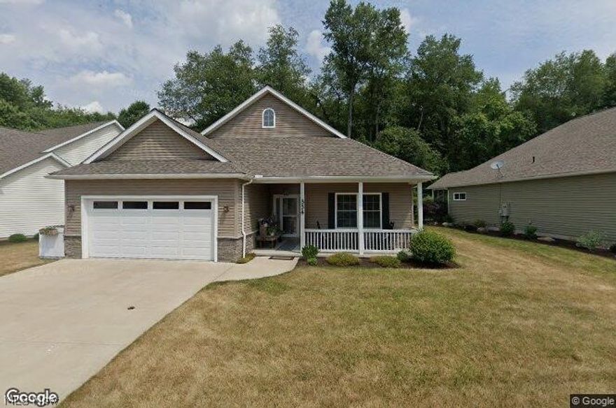 One Story living at its finest, this three bedroom home has two full baths. Home was built on an exterior upgraded wooded lot and offers plenty of privacy while sitting on the concrete rear patio. The covered front porch opens to a foyer and open floor plan great room. Gas fireplace and wall of windows for plenty of natural lighting. Kitchen, dining and laundry room has plenty of cabinetry, kitchen offers a breakfast bar. A two car attached garage with opener and hot/cold water. The owners suite offers vaulted ceilings and has a private bath with walk in closet. The association offers community pond, covered pavilion and playground and walk a short distance from the front door you can walk to Towpath Trail entrance.  Upgrades: carpet with exceptional padding, blinds 2014, new storm door, privacy fence 2016, doubled patio 2017, backsplash kitchen and master bath tub, kitchen faucet, closet organizer in 2nd bedroom, and landscaping 2018. Walk, bike, hike on the Towpath Trail, fish or relax at the community pond, picnic under covered pavilion, swing the afternoon away on the playground (adults and children alike). Affordable monthly fee also covers lawn and snow removal. Seller to find home of choice.