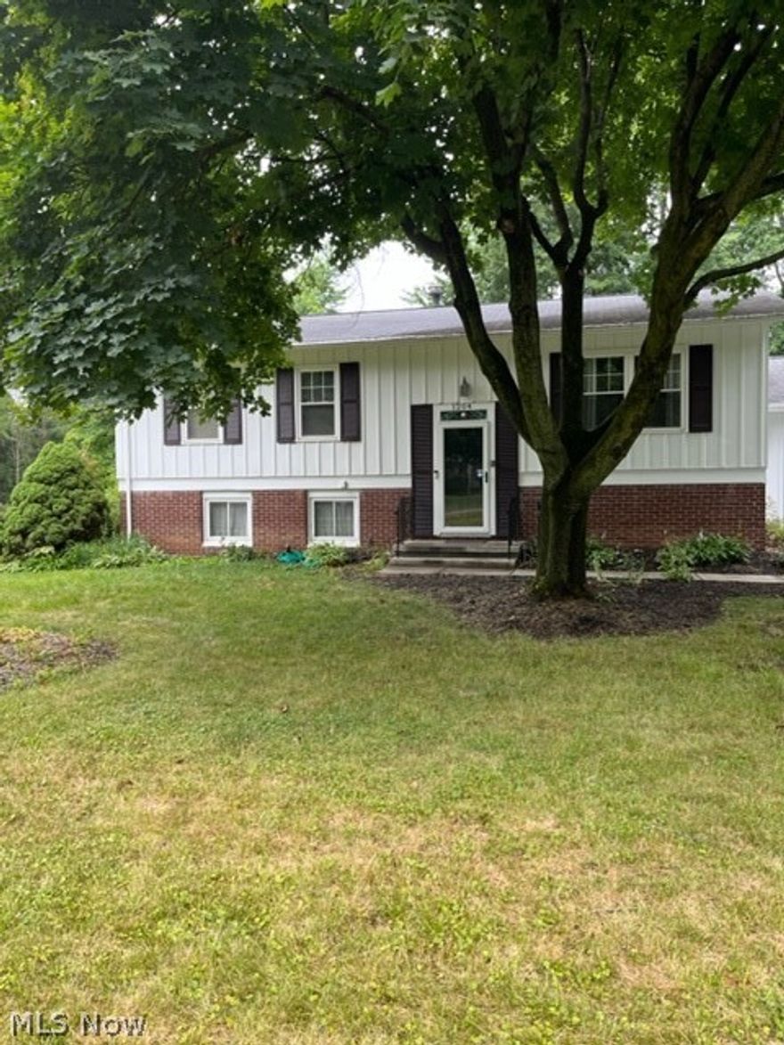 Well loved family bi-level home available now for you to add your personal touch and build your own memories.  The upper level features a cozy living room, dining area to accommodate all of your gatherings as well as a screened porch to enjoy the warm summer nights.  There is original hardwood flooring under the carpet.  Lower level is partially finished for additional living space including a wood burning fireplace.   Laundry and work shop fill the remainder of the lower level.   This location can't be beat!  Close to all Kent has to offer but just far enough from the "city".   Minutes to Fred Fuller Park and the Portage Bike and Hike trail.