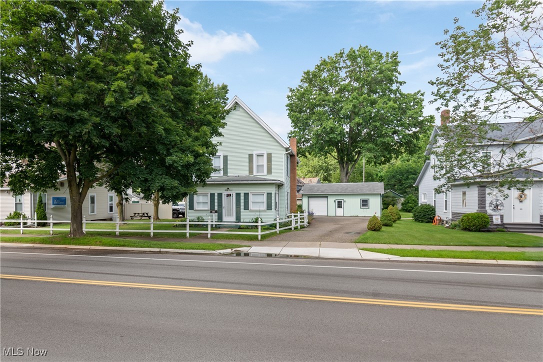 Charming home with white picket fence and enclosed front porch! This 3-bedroom, 2-bathroom home offers a unique layout—Bedroom 2 is accessible through Bedroom 1, ideal for a nursery, office, or dressing room. Full baths on both the main and upper levels. Enjoy the natural light in the enclosed front porch and relax on the screened-in back porch. The 23x30 detached garage with one overhead door offers convenient storage or parking.