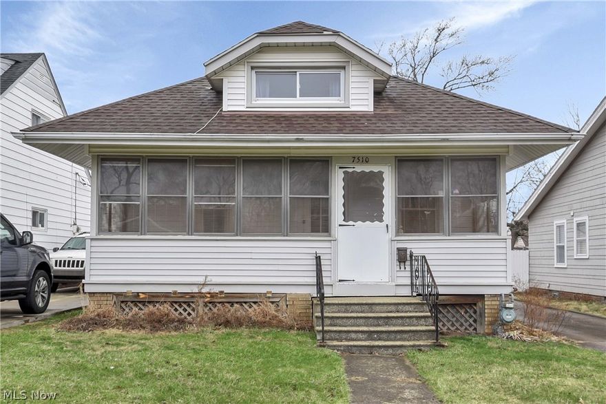 Prepare to be moved! Welcome to 7510 Manhattan Avenue, a charming bungalow located in a quiet, established Parma neighborhood. Offering about 1,215 square feet of living space, this home presents a great opportunity to add your personal style while enjoying its classic character and practical layout. Step into the enclosed front porch, a bright and inviting entry perfect for morning coffee or relaxing. Inside, the traditional floor plan features 3 comfortable bedrooms and one 1 bathroom, making it ideal for a starter home or investment property. The living room showcases original dark wood trim and wide doorways that create an easy flow into the dining and nearby bedrooms. The dining room is filled with natural light from large windows overlooking the side yard and features 2 original built-in corner cabinets with glass-pane doors, perfect for displaying collectibles or storage. The kitchen offers warm wood cabinetry with ample storage, a classic white tile backsplash, and neutral countertops that create a clean workspace. Just off the kitchen is a generously sized pantry with wraparound shelving for groceries, and household essentials.  The main level includes 2 well-proportioned bedrooms, offering convenient first-floor living. Upstairs, a spacious 3rd bedroom with built-in shelving provides flexible space for a primary suite, home office, or library.  The full basement offers room for storage, a workshop, home gym, or expanded laundry area and includes a utility sink and updated electrical panel. Outside, the fenced backyard provides a private setting for gardening, or gatherings around the cozy fire pit. A one-car detached garage and paved driveway add off-street parking. Updates include furnace (2025), hot water tank (2025) and air conditioner (2024). Located near highways, shopping, dining, and just minutes from Cleveland with beautiful Metroparks offering scenic trails for walking, running, biking, and bird watching. Schedule your showing today!