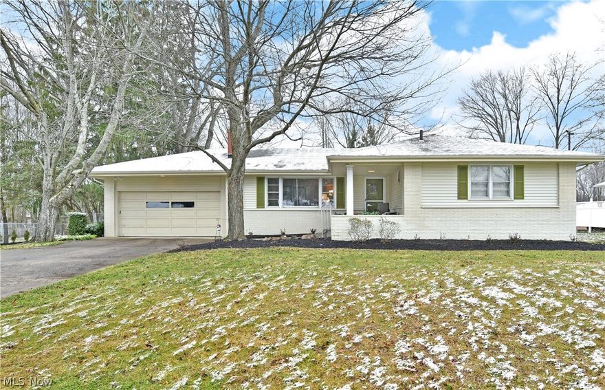 Don’t miss the huge potential of this sprawling Howland ranch, offering up an impressive amount of living space and a huge, partially finished basement with potential for even more! Set in a desirable neighborhood, this residence features a scenic lot with a fenced in backyard, allowing for easy relaxation from its sizable brick patio space. A bonus sunroom ensures year-round enjoyment with additional dining space as well as entertainment area. The covered front patio leads you inside where a welcoming living room focuses around a stone fireplace. Natural light pours from the picture window, spilling into the nearby kitchen and dining areas. Here, hard surface flooring runs beneath the white cabinetry and stainless-steel appliances. A wrapping chair rail continues through multiple built-in storage spaces as they continue past the sunroom entrance toward the oversized primary bedroom suite. An additional bedroom suite + two more bedrooms sweep the main hallway with handsome woodwork as