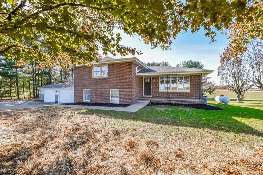 Beautifully remodeled 3 bedroom split level with garage space for 4 cars! Luxury vinyl plank flooring flows from the living room into the eat-in kitchen with gorgeous granite countertops, stainless steel appliances, soft close cabinetry and breakfast bar seating. The family room boasts a wood burning fireplace with brick surround and view into the sunroom with a ceiling fan and access to a concrete patio. The great room adds a wet bar with butcher block counter, huge bow window and a built-in bookcase. Three upper level bedrooms and two full baths. The master features two double closets and a private full bath with a shiplap accent wall. The secondary bedrooms share the remodeled full bath off the hall. A 3 car side load garage is attached to the home while a 1 car detached garage is available for additional storage. If you're looking for a spacious home, full of updates and a rural setting in Louisville schools, this is it! Call to schedule your showing today!
