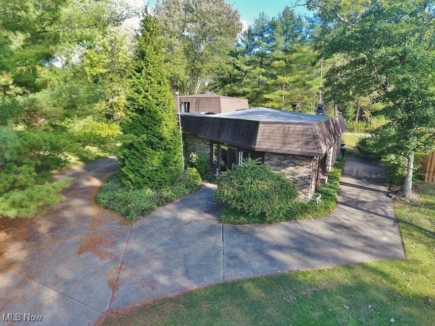 This unique Atwood Lake ranch home on a beautiful lot with mature trees in the popular Atwood Pines community has so much to offer either as a second home or year round lake living. Three bedrooms and 2 bathrooms in the main home for your family to enjoy as well as a charming private studio guest quarters above the garage. Come and put your personal touches to work & make it your own. Of course, a private dock is included for your nautical toys located in a calm bay across from the Atwood Yacht Club. The spacious living room offers great natural light & a gas stove to take off the chill on cool evenings. A galley kitchen includes all the appliances & a eat at bar. Dining area & a bonus area adjoin the kitchen and could make a great location for a home office or an additional dining area. The master bedroom provides a full private bath for the owners. Two spacious guest bedrooms feature convenient built-ins with counter tops. A concrete driveway leads to a convenient attached two car garage. Accessed above the garage is the bonus guest quarters which would also be an incredible location for a home office which features a full kitchen & separate bath.  If you enjoy gardening, you will love the 16x16 green house to grow your flowers & vegetables. Great flat yard space to enjoy family fun or for pets. Beautiful, yet easy to maintain landscaping. A second  driveway is convenient for additional parking or winter boat storage. The Atwood Yacht Club is an easy walk away. Enjoy a 5.5 mile bike & walking path conveniently accessed & running along  Lodge Road. This is a MWCD leased lot with the affordable 2024 lease rate of $2,190. Call to arrange your personal showing today and be sure to view the 3D virtual tour for incredible detail.