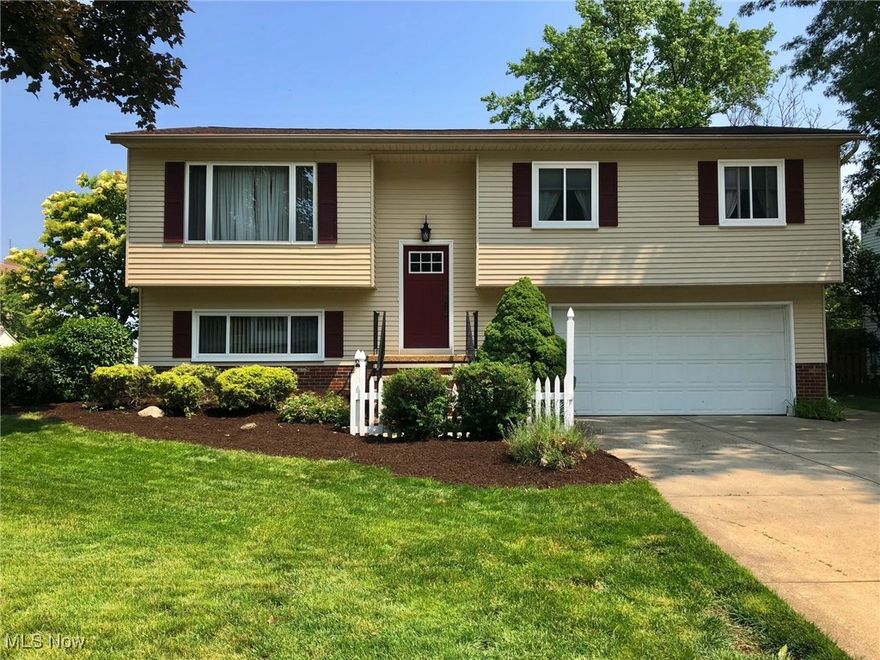 This beautiful, spacious home is situated on a picturesque, private lot with no rear neighbors in South Parma. Features include: Granite countertop, luxury vinyl tile and upgraded appliances in kitchen; main floor family room with wood burning fireplace; patio door leads to lovely large deck. Don't miss the enormous master bedroom (that can be converted back to 2 bedrooms if 4  bedrooms are necessary). The main bath has a convenient walk-in tiled shower and separate bathtub. The lower level features a third bedroom, convenient separate office space and a lower-level family room with access to the patio through a newer sliding glass door. Upgrades include: Roof 2025;  HWT 2021;  HVAC 2010; a plus all newer interior doors, newer carpets and flooring throughout, and some new light fixtures. The backyard is completely fenced and has many perennials and ornamental trees that creates a serene setting.  Conveniently located near schools, churches and shopping, this home is waiting for you! Welcome Home!