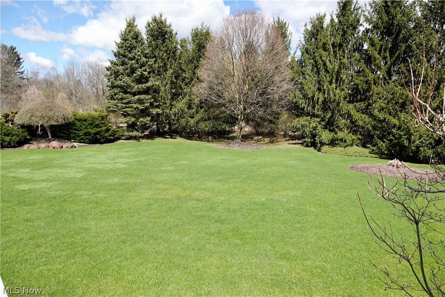 Welcome to the highly desirable Woods of Wembley, situated just outside historic Chagrin Falls Village where luxury, location, and lifestyle all come together. This impeccably maintained home is situated on a private one acre lot which offers plenty of outdoor entertaining options whether on the beautiful deck or on the paver patio with fire pit and tranquil water feature. The first floor features open spaces and bountiful natural light. The vaulted great room with its soaring fireplace and custom built-ins is at the center of this home. First floor primary suite offers a quaint sitting area, fireplace, his/hers walk-in closets, and glamour bathroom. A formal dining room with coffered ceiling is a wonderful place to entertain on those special occasions. Also on the first floor is a private office with custom built-ins an another fireplace. The second floor is compared of three bedrooms and two full bathrooms, one en-suite and one Jack & Jill. The expansive finished lower level is designed for pure enjoyment offering a private theater room, as well as multiple sitting areas with wet bar, fireplace, and a full bathroom. The Woods of Wembley is situated minutes from Chagrin Falls Village and with the Kenston School District. Membership at the Wembley Club gives you access to tennis & pickle ball courts, swimming, dining, and more.