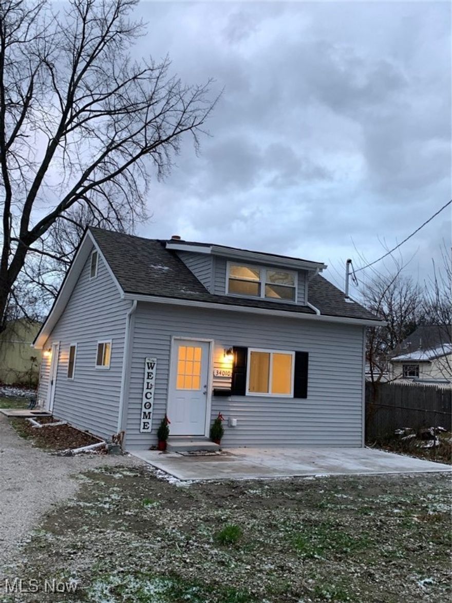 Cute, Totally Renovated Cozy Home! All new in 2025: New roof, new windows, siding, doors, concrete front slab patio area and side door area concrete slab. Inside new kitchen including new cabinets, stainless steel appliances. New flooring and lighting in whole house. New furnace. New bathroom includes new vanity, sink, toilet, tub surround. 1 bedroom down, spacious loft area with closet upstairs. Close to shopping, restaurants, freeway access and Lake Erie Parks! Move-in ready! Come check out this adorable home!