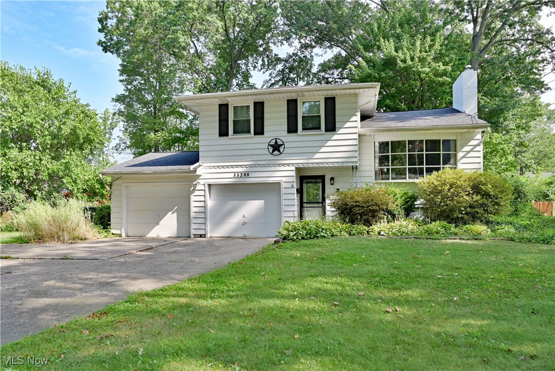 Check out this split-level home on an almost half acre lot near the Lake Erie shorelines. Vaulted ceilings & huge bay window keep the living room and adjacent dining room open & airy while the floor-to-ceiling brick fireplace makes a dramatic statement. Open floor plan to the spacious kitchen with tile backsplash and abundant cabinets. The screened in four seasons sunroom will give you extra space and let you enjoy the back yard all year long. Upstairs offers a master bedroom with a large walk-in closet and attached master bath & second full bath serves the additional two bedrooms. The lower level features a large family room with picture window and slider doors. Downstairs is equipped with additional living space, a large laundry room, extra bedroom and/or office/workout room. The downstairs also has easy access crawl space that is great for storage. The driveway has ample parking with extra concrete pad for additional parking or turn-around & an attached oversized garage that leads to the fully fenced back yard with small view of lake.