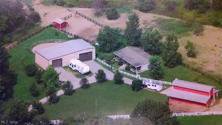 Manufactured home with long country front porch.  6 Stall horse barn with a riding arena and some board fencing. 2 x tra sheds and a hugh 40' by 70' heated workshop/garage. Beautiful coy fish pond. MINERAL RIGHTS DO NOT TRANSFER OWNER KEEPING ALL MINERAL RIGHTS