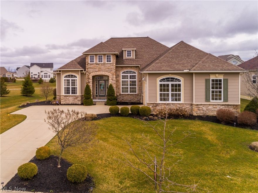 Absolutely stunning 3 bedroom, 3 bath ranch built 2008 (builders model) with 2319SF plus 1100SF finished lower level & every possible upgrade* Impressive open floor plan (split bedroom arrangement), soaring ceilings, 8' raised panel doors, extra wide base trim & crown, maple hardwood floors throughout foyer, great room, den, dining room, kitchen & sun room and floor to ceiling ledgestone fireplace visible from most rooms* Den with palladium window & French doors off of foyer* Formal dining room with 12' custom crowned double tray ceiling & mirror accent wall* Gourmet cherry kitchen with 8' island, granite counter top, walk-in corner pantry, stainless appliances & vaulted eating area/sun room with slider to deck* Master bedroom with detailed crowned tray ceiling, his & her walk in closets, glamour bath with corner garden tub, double granite vanity & separate shower* Spacious 1st floor laundry with closet & utility tub* Finished basement approx. 1100SF, light and bright with full bath (1