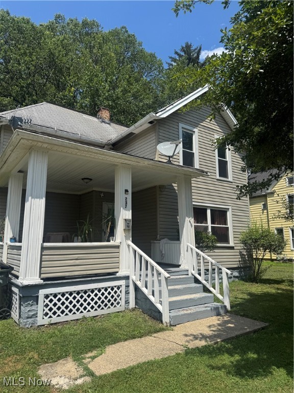 Welcome to this 4-bedroom colonial with classic character and some updates. The home features fresh paint and newer flooring in areas, offering a good starting point for the next owner. The covered front porch, vinyl siding, and vinyl windows provide low-maintenance exterior features. Inside, the living room connects to a formal dining space with a decorative chandelier. The kitchen has updated cabinetry, vinyl plank flooring, and a ceiling fan. A remodeled full bath, first-floor laundry, and a main-level bedroom with a large closet add some functional space. Upstairs offers three bedrooms with closets, a bonus storage cubby, and a second full bath with an updated tub and vanity. The home is being Sold As Is and still has opportunities for further improvements—come see its potential!