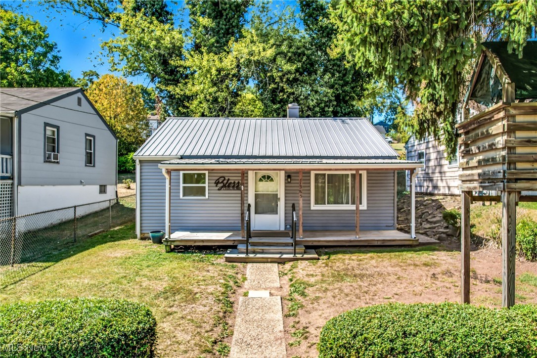 Step into the comfort of this charming single-family ranch home, nestled in a serene East Liverpool neighborhood. Perfect for those looking for an intimate living space, this residence boasts two cozy bedrooms and a full bathroom, all designed to create a warm and inviting atmosphere. The house is topped with a newer metal roof, providing peace of mind for years to come.
Enjoy your morning coffee or evening relaxation on either the front or back deck, each offering a tranquil space to unwind. This home is a stone's throw away from the picturesque Ohio River, inviting you to explore the scenic surroundings. Ideal for buyers seeking a tranquil retreat, this property promises a blend of convenience and comfort. Make it your own sanctuary today!