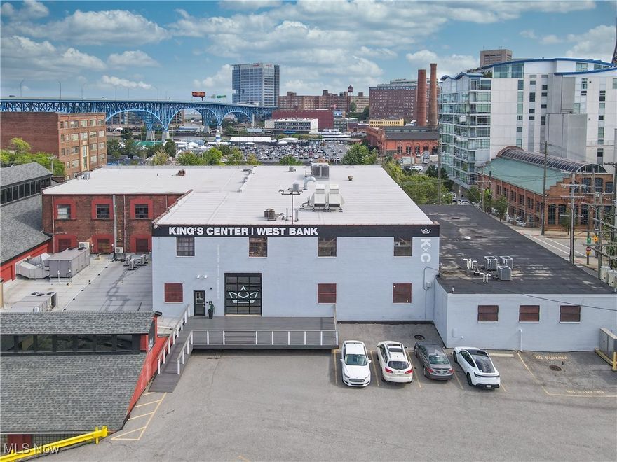 Discover an exceptional leasing opportunity at 2111 Center Street, located in the heart of Cleveland’s West Bank of the Flats. This recently renovated property offers over 13,000 square feet of highly flexible space, designed to accommodate a wide range of uses including office, creative studios, training centers, coworking, community organizations, and event programming. there is 5757 additional SF. of warehouse space with 50' ceilings! The building features a thoughtfully reimagined interior with modern upgrades throughout, including high, open-beam ceilings, exposed brick walls, abundant natural light from oversized windows, and new flooring, lighting, and mechanical improvements. A mix of expansive open-plan areas and private offices provides versatility for tenants of all sizes, while multiple conference rooms, training rooms, and gathering spaces support collaborative work and large-scale programming. Amenities include stylish lounge and meeting areas, a modern bar/kitchenette, updated ADA-compliant restrooms, and ample storage. Recent capital improvements include newer HVAC systems, upgraded electrical and plumbing, refreshed common areas, and enhanced accessibility. The property also offers dedicated on-site parking, a rarity in the Flats, along with convenient access to all major highways, downtown Cleveland, and surrounding neighborhoods. With its combination of historic character, modern upgrades, and highly adaptable layouts, 2111 Center Street represents a unique opportunity for organizations seeking a signature space in one of Cleveland’s most vibrant districts.