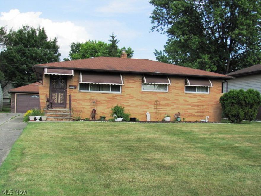Brick ranch first floor features hardwood floors and updated kitchen appliance that will remain.  Kitchen patio door leads to back deck and spacious lot.  Two car garage has drain and garage door opener.  Basement is full and has large recreation room, glass block windows and full bath.  Separate laundry area; more than ample storage.  Updated furnace.  Owner is offering a one year home warranty to the new homeowner. Home is close to I-480 and I-271 great location.