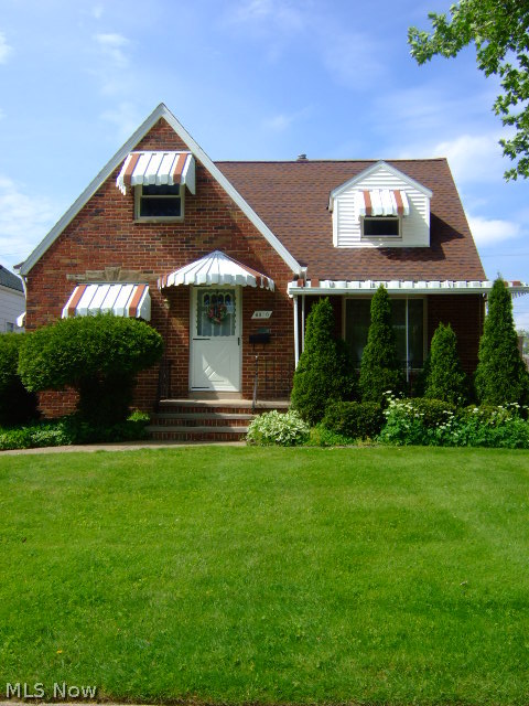 Move in & enjoy this charming solid all brick cape! Greet your guests in the charming entry w glass panel door. The spacious living rm features neutral décor & decorative FP. Newer carpet throughout w hardwd floors underneath. The eat- in kitchen features updtd/refaced cabinets, a newer refrigerator & spacious dinette. There are 2 bedrms w ample closet space on the first floor. The upper level features a huge master suite w private bath, gleaming hardwd floors, sitting nook & loads of storage space! The cozy bonus rm w beaut. hardwd floors would be a great home office or play rm . The recreation room on the LL is a great space for entertaining! It features glass block wndws, beaut. paneled walls and fun game themed flooring. The utility rm features a cheery laundry area & a separate work area. Updates: garage roof (5/14), furnace and A/C (9/09), H2O tank (5/09), refrigerator (9/09), gutter toppers (8/06), kitchen cabs refaced (10/03) and more! Fab covered front porch! 2 car garage