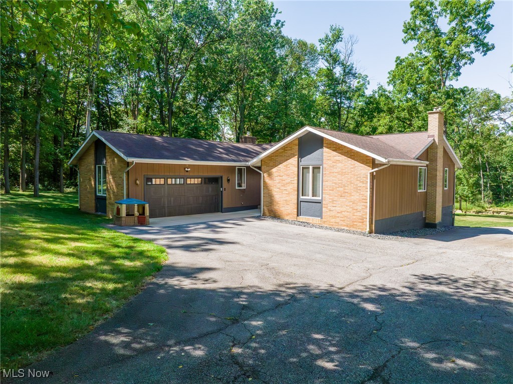 On-site auction Monday, September 22nd at 6:00 PM. Located just minutes from Apple Creek, this beautifully updated property offers comfort, versatility, and space. Set on 2.5 acres, the 3-bedroom, 2.5-bath home has seen extensive improvements, including a full interior repaint and remodel, a brand-new kitchen, and modernized bathrooms. The main floor features a stylish kitchen, dining room, living room with a cozy natural gas fireplace, three bedrooms, and a full bath. An attached 2-car garage includes the laundry area for added convenience. The full walk-out basement expands your living space with a finished bonus room, small kitchen, office, fruit cellar, storage areas, and an additional living room — ideal for guests or extended family. Modern utilities include an on-demand tankless water heater, natural gas forced-air furnace, central A/C, well, and septic. A complete solar system with backup generator ensures energy efficiency and peace of mind. Outdoor living shines with an amazing stamped concrete patio with a covered pavilion — perfect for gatherings. The detached 32’ x 48’ shop is insulated, heated, wired, plumbed, and even has its own bathroom. This move-in-ready property offers the perfect blend of rural living and modern convenience — all within a well-maintained, thoughtfully upgraded home.