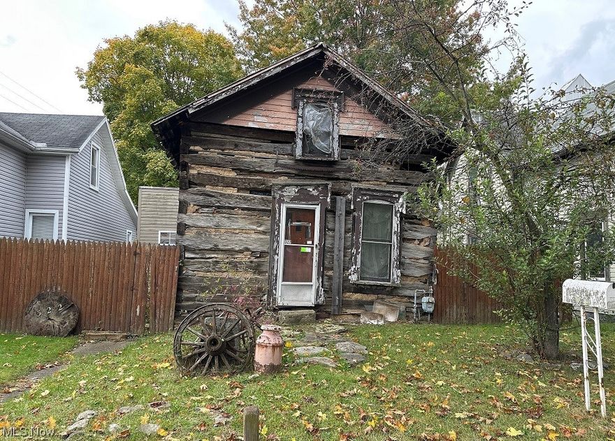 Log cabin in town! This home has been built out and partially remodeled. Enter through the rear of the home and come into a large living area with open concept kitchen-living. There is a large remodeled bathroom that includes a urinal, toilet vanity and tub, laundry hookup area and a beautiful tiled floor. There is a 2nd full bathroom and rest of the inside has been opened up and is waiting for your finishing touch!
