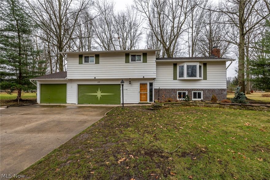 Welcome home to 110 Laurie Lane located in the heart of Northfield Center. Situated on over a half acre and tucked away on a quiet street puts this home in the perfect location.   Greeted by a large foyer area, you immediately notice the openness this floorplan has to offer.  Spacious living room boasts three large windows giving off an abundance of natural lighting, original hardwood floors and sits adjacent to the dining room.  Open kitchen features plenty of cabinet and countertop space for your convenience and overlooks the backyard area.  Four nice size bedrooms all with spacious closets and original hardwood flooring are located on the third level.  Lower level features a finished family room area with a wood burning fireplace and large laundry room thats located next to it. Convenient three car attached garage makes life much simpler in the cold winter months. Large enclosed patio located just off the garage area is perfect for relaxing in the Spring, Summer and Fall months. Exp