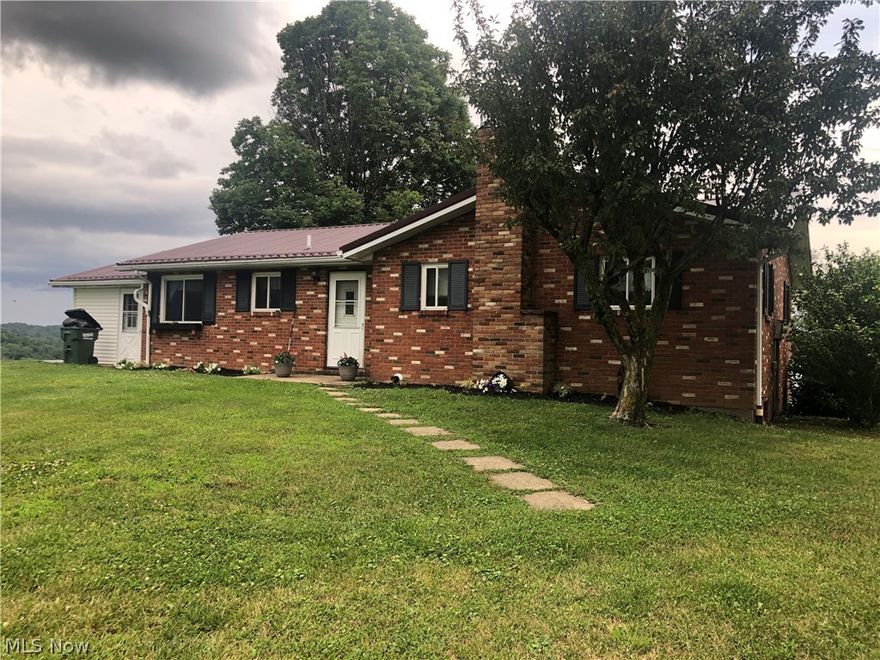 Beautiful country setting! Brick Ranch home on 1.9 acres. 3 bedroom/2 bath with a finished lower level, an attached 2-car and detached 24X24 garage. Enclosed front porch. Country living with a great view!