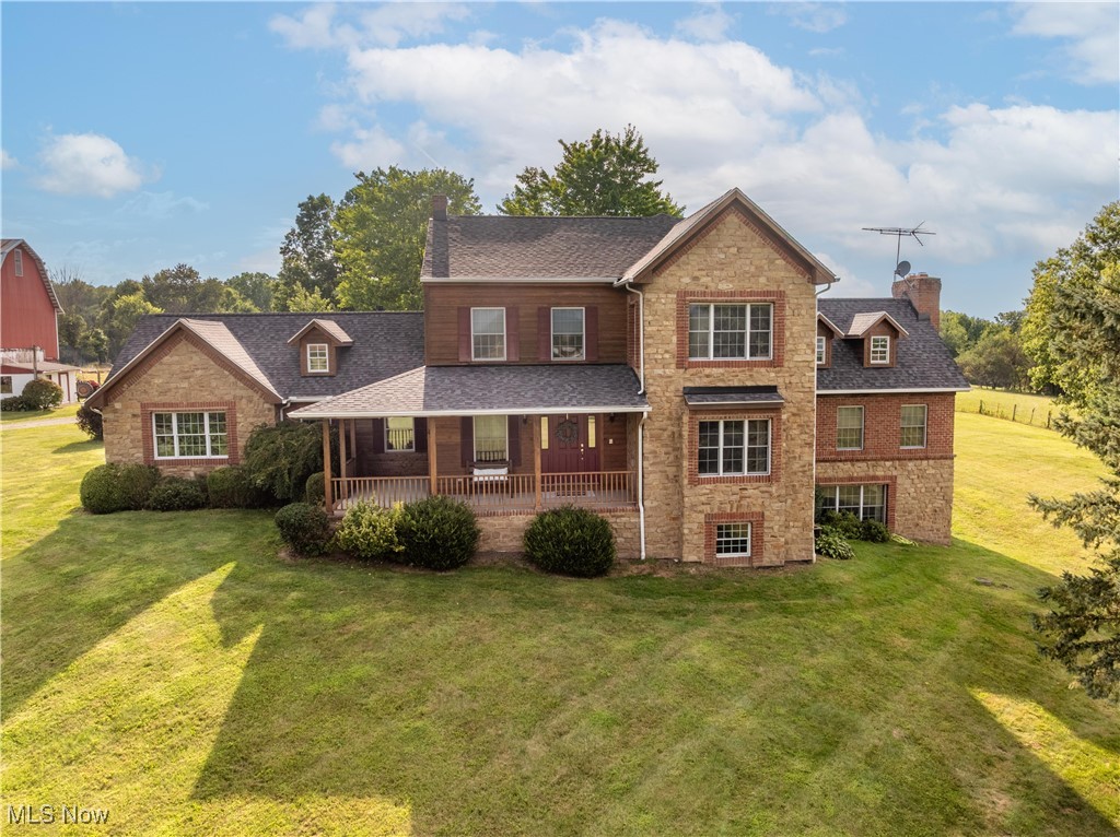 This brick, stone, and cedar-sided home, nestled on 20 acres, this property offers the perfect blend of privacy and timeless rustic elegance. Detailed brick archways and solid wood doors throughout add character. The 65x30 two-level bank barn includes three stalls, 220 amp service, and a heated milk house. Approximately 15 acres of fenced pasture, currently home to Scottish Highland cows, make this an ideal setting for livestock or hobby farming.The 4-bdrm, 3.5-bath home offers FREE, UNLIMITED NATURAL GAS, two hot water tanks (2025), and a heated garage. The roof and gutters in 2024. Inside, you'll find a spacious, layout with abundant storage and oversized closets throughout. Walk in foyer closet offers plenty of space for coats and shelves for storage. Coming in from the garage another walk in closet offers shelving for shoes and ample storage for coats The open-concept kitchen and family room serve as the heart of the home, featuring a double oven, gas cooktop, extra-large island, farmhouse sink, and an abundance of cabinetry. The adjoining family room is warm and inviting, anchored by a wood-burning fireplace and surrounded by windows and doors. The main level also features a formal dining room with hardwood floors, a first-floor bedroom with custom built-ins—ideal for use as a home office. The main floor offers a half bath and a full bath conveniently located off of the laundry room, a spacious laundry room with cabinetry .A generous great room with another wood-burning fireplace and views of the scenic front and backyard. Upstairs, the master suite is a retreat, offering a vaulted ceiling, sitting area, walk-in closet, and a master bath with a soaking tub perfectly positioned to take in views of the private backyard. Two guest bedrooms complete the upper level, each offering walk-in closets and generous space. These bedrooms share a Jack and Jill bathroom. The walk-out basement, with a wood-burning fireplace. 30 min to Canton & 20 min to Wooster & Akron