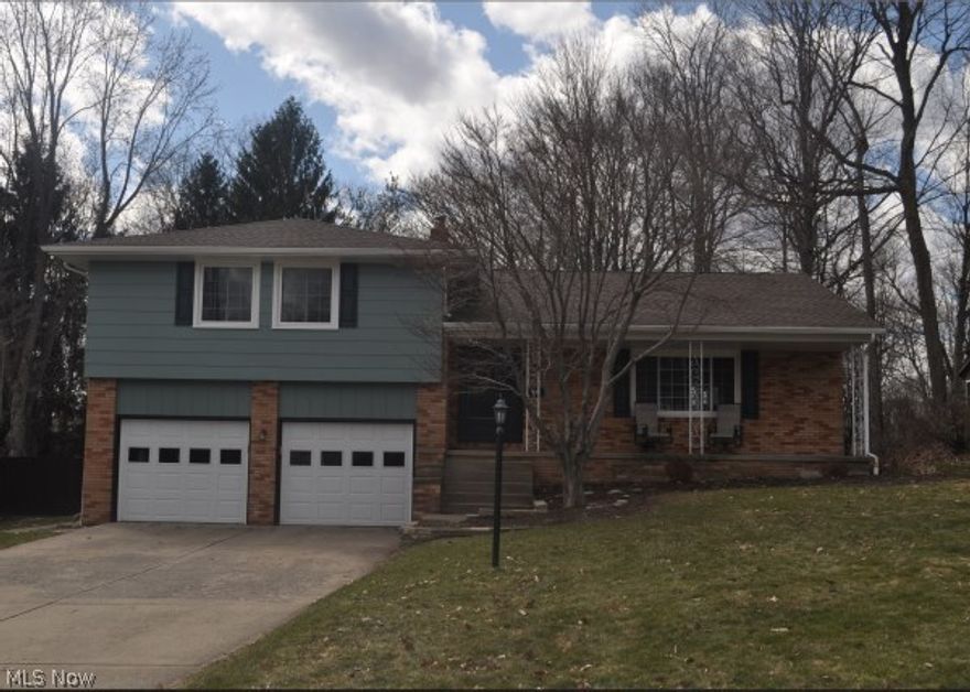 Spacious split in great neighborhood with $35K improvements galore in the past year. They include roof, gutters, garage doors, Polaris windows in the entire home, added dining room Polaris patio door, carpet, top-of-the-line kitchen appliances, light fixtures, fans, hot water heater, paint both interior & exterior. Large rooms throughout with formal dining & living rooms, eat-in kitchen, family room w/fireplace & enclosed porch. Living room, dining room & main bedrooms have hardwood floors. Large master with master bath. Lower level has 568 additional living space currently used as 4th bedroom & office. Close to Swim & Tennis Club. Priced to sell.