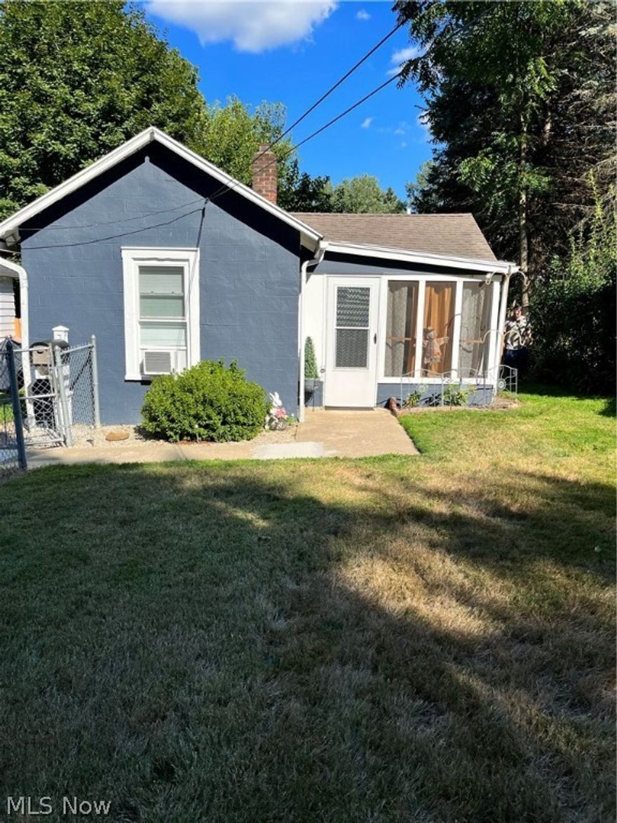 Welcome to this charming, inviting remodeled home. As you walk in through the enclosed screened porch, perfect for summer relaxation, you will see the freshly painted the walls in shades of light gray, and the new carpet in the cozy living room.  All new white trim and a new wood mantle over the brick firepalce with electric logs. The spacious eat in kitchen features new flooring and glass backsplash.  Plenty of counter space, oak cabinets and stainless steel double sink.  There is plenty of space for a round or oblong table. New lighting, too.  The laundry room, with washer and dryer, also is the back door enrty and stairs to the partial basement with newer furnace, approximately 2 years old. The bedroom features new carpet, paint and a double closet. The bathroom is remodeled with a new vanity, fixtures, mirror, lighting, commode and flooring.  Tub/shower, too.  There is all new trim throughout. As you walk around the yard you will notice it is  entirley fenced. There is a shed in th