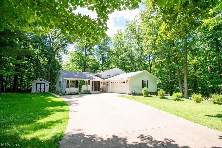 This spectacular 3 bedroom, 2 FULL bathroom remodeled split level home offers not 1, not 2, but 3 levels of floor plan...and entertaining! Surrounded by lush fields of greenery and beautiful landscaping, this home offers unmatched scenery! A new TOP OF THE LINE Mitsubishi mini-split air conditioner has been added August 2019.  A pleasant creek aggressively flows when rain hits, but is incredibly calm during a sunny day and sits a few hundred feet behind the house where you can walk down to it. There are plenty of the city's amenities nearby, but also within 10 minutes is MGM Northfield Park and Macedonia Commons for shopping! The Cleveland Metroparks is a swift walk away! The interior of the home is quite special, offering a gourmet kitchen with a huge center island. Flowing into the dining and living room, the kitchen has a breakfast island big enough to hold pans and pans of food for family get-togethers. Walking downstairs-only about 8 steps-is a finished walk out basement that open