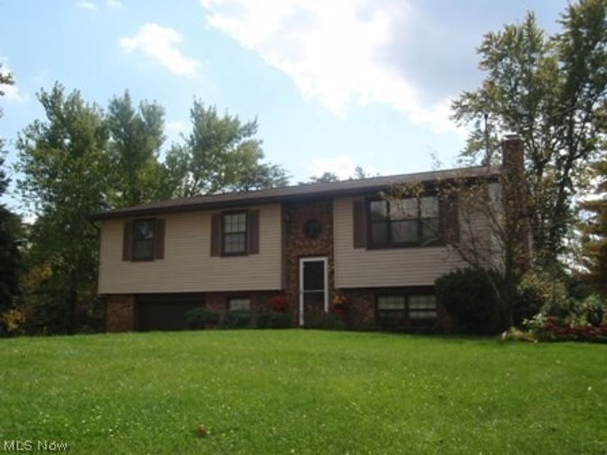 This attractive 3 bedrooms, 2 ½ baths home is  situated on a large level lot (.57 acres) with mature trees and offers over 2000 square feet of finished living space.  Features nice entry and stairs, spacious great room with table space, wall space for a large hutch,  and beautiful door with opening sidelights to tiered decking and patio area overlooking the private backyard, gourmet chef’s kitchen with granite counter tops, lots of nice newer cabinetry and appliances, master suite with walk-in closet, newer private bath (double vanity, granite counter top, large walk-in shower and tile flooring),  updated hall bath with tub/shower and tile flooring, family/rec room with wood burning fireplace and good space for big screen television or pool table, a large half bath/laundry room with wall of storage closet, folding stand and tile flooring completes this inviting home.  The home has neutral décor, wood floating floor, carpet and tile flooring, tasteful decorating, new forced air heat wit