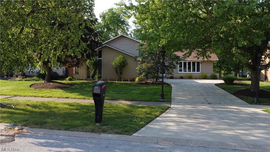 This gorgeous split-level home is nestled in the highly sought after area of Indian Creek Estates. All three bedrooms feature hardwood floors and plenty of storage. The primary bedroom also has a full bathroom, walk in closet, and built in vanity. The main floor features vaulted ceilings in the living room and dining room and a beautiful curved staircase. The lower living room has a fire place, built in bar and a sliding glass door that provides access to the back patio. There is also a den/office and a massive laundry room. The sliding glass door off of the kitchen leads to the gorgeous back patio and fenced in yard. Imagine entertaining your family and friends with the wood burning fire pit and brand new built-in grill. The solar lights tie this patio together to make a great place to relax and visit even after the sun sets! The basement serves as a bonus billiard room with a built in bar and a large storage area. The attached garage has built in cabinets and a freshly painted floor.