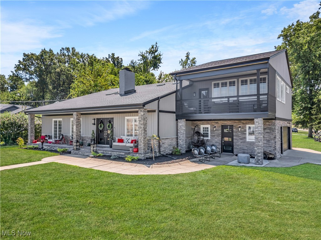 Discover the epitome of elegance and modern living in this stunning property, perfectly situated with breathtaking views of Lake Erie. The exterior captivates with its sophisticated greys and stone, beautifully complemented by meticulous landscaping and mature trees that create a serene and inviting atmosphere. Positioned on a desirable corner lot, this home features charming sidewalks that enhance the neighborhood's allure. Enter through the grand double doors and be greeted by a magnificent floor-to-ceiling stone fireplace, seamlessly linking the impressive two-story living area with the formal dining space. The contemporary kitchen, equipped with stainless steel appliances and elegant white cabinetry with soft-close features, opens gracefully to both the formal dining area and an inviting addition with a cozy two-sided fireplace, ideal for festive holiday celebrations! At the heart of the home is the expansive Great Room, featuring the two-sided cozy fireplace and access to the outdoors and indoor heated pool, making it ideal for both intimate family moments and lively celebrations! The master suite, enhanced by vaulted ceilings, walls of windows, and beautiful hardwood floors, serves as a sanctuary with its updated spa-like ensuite bathroom, spacious organized walk-in closet, wet bar, and a walkout second screened-in private porch, perfect for enjoying morning coffee while taking in the incredible views of the Lake. This level also includes another spacious updated spa-like bath, three additional bedrooms, a large loft-like hall, and a convenient second-floor laundry. Some recent updates include New roofs, A/C units, Skylights, Lighting, Landscape, Siding, Insulation, Doors, Appliances, 10 New Windows. Additional highlights include easy access from the attached garage into the organized mudroom with storage, a charming she shed/kids playhouse. Embrace the perfect blend of Location, Serenity and Beauty in a home that truly embodies the essence of refined living!