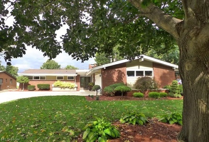 Edgewater Updated Ranch with over 2860 square feet of living space! This home is magnificent with vaulted ceilings, open floor plan and three fireplaces! Huge Eat-in Kitchen with newer stainless steel appliances, large double pantry, ceramic tile flooring and double sided wood burning fireplace in hearth room. Living Room & Dining Room w/ ceramic tile floors, exposed brick and vaulted walls of windows overlooking back yard. Main floor Sun Room/Family Room has travertine flooring, glass block windows, planked wood ceiling and a gorgeous stone wood burning fireplace. It even has an inside grill! Main bathroom has marble shower and Master bathroom has double sinks, granite countertops, granite floor & jacuzzi tub! Three bedrooms on the main floor with laminate wood floors, master has new carpeting. Incredible lower level has been exquisitely remodeled as a home office with travertine tile flooring, custom woodwork & cabinetry & newer carpeting on stairs. 2 car attached garage, newer cemen