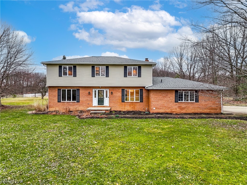 Nestled on a 5-acre lot, this home offers country tranquility with quick access to Historic Hudson. This home is equipped with a 2-stall horse barn with an arena, and additional outbuilding. It's a true piece of paradise.
The spacious foyer sets the tone for the rest of the home, inviting you to explore the thoughtful design and layout with a beautifully updated kitchen with granite and an eat-in area (2019) and dining room (2023) that overlooks the amazing backyard. The first floor also contains a nicely updated half bath (2020) and spacious laundry room along with a 2 separate, oversized family/living rooms, one complete with a beautiful all-brick fireplace and LVT flooring (2022). Upstairs you'll find three large bedrooms. The primary bedroom has large walk-in closet and on-suite bathroom. The secondary bedrooms are not only large but also have ample closet storage. A gorgeous updated hall bath rounds out the second floor of the home. The large unfinished basement contains the second set of washer/dryer as well as the tankless water heater (2022) and additional storage. Don't miss out on your chance to make this house your home!