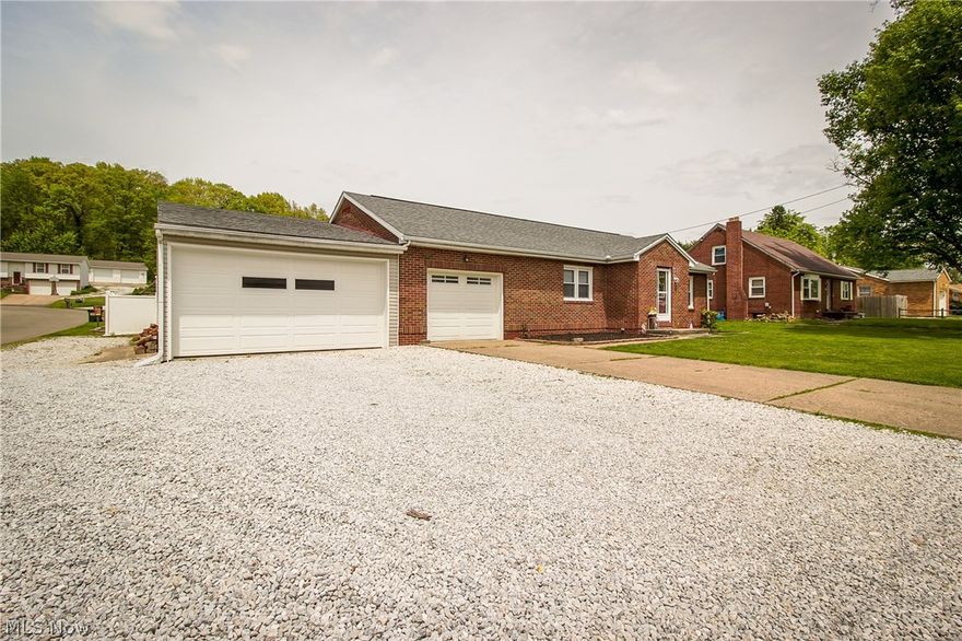 Great brick ranch on a corner lot!  Step into the foyer with ceramic tile floor which leads to the living room with neutral carpet. The kitchen is quite large and features stainless appliances, lots of cabinet and counter space, updated countertops and ceramic tile floor.  You'll love the master bedroom with French doors leading to the deck plus there's a second bedroom with two closets, fresh paint and newer carpet.  Both bedrooms share the full bath with built in linen storage.  An enclosed porch overlooks the pool and leads to a half bath in the garage.  The lower level has three partially finished rooms, great for additional entertaining space plus a laundry with electric and gas hook-ups.  The garage space is perfect for the hobbyist with room for 3 cars plus space for a workshop and additional parking on the side.  The fully fenced back yard features a maintenance free composite deck with vinyl railing, water feature at the back of the lot plus a 16 x 32 in-ground pool with gas heater!  Updates include Water heater 04, Roof & furnace 05, Windows 06, Electric 06, Appliances 06, Vinyl fence 08, Kitchen 08,French doors 10, Pool heater 14, Garage doors & opener 15-all dates approximate.  Seller is offering a one year home warranty for added peace of mind!