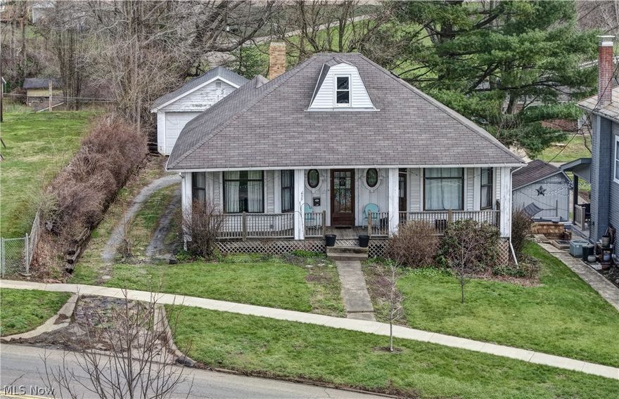 Here’s a gem — a craftsman-style bungalow beside the park, featuring front and back porches, raised garden beds, and a detached garage. Step inside to a welcoming entry with beautiful woodwork and hardwood flooring throughout, 2 bedrooms, and a cozy living and dining area. The kitchen is fully applianced with an eat-in spot, plus a built-in coffee bar area between the living room and kitchen — perfect for your morning routine. Upstairs offers a flexible space for a bedroom, office, or hobby room, and the unfinished basement has laundry with easy outside access. With gas heat, city water/sewer, and plenty of character, this home is ideal for a first-time buyer, investor, or Airbnb.