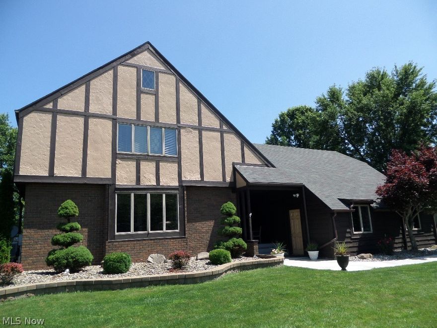 Old world elegance in this huge 2800 sq. ft. Howland Tudor two-story in Avalon Estates.  Much creativity is exemplified in this unique floor plan with its open foyer leading to a large formal living room, huge dining room, then to the redone kitchen with granite counters and stainless appliances.  A family room with exquisite fireplace leads to a screened side summer room with access to the patio and large covered breezeway.  Outdoor living is a joy with a pond and falls off the patio and a firepit too.  The basement features a media room, full bathroom, and several rooms for various uses and storage. The second floor offers a master bedroom suite with a lounge area, unbelievable master bath, vanity area and walk-in closet.  Three more bedrooms and a main bath complete the upper level.  2.5 car garage. Wonderful home for entertaining inside and out.