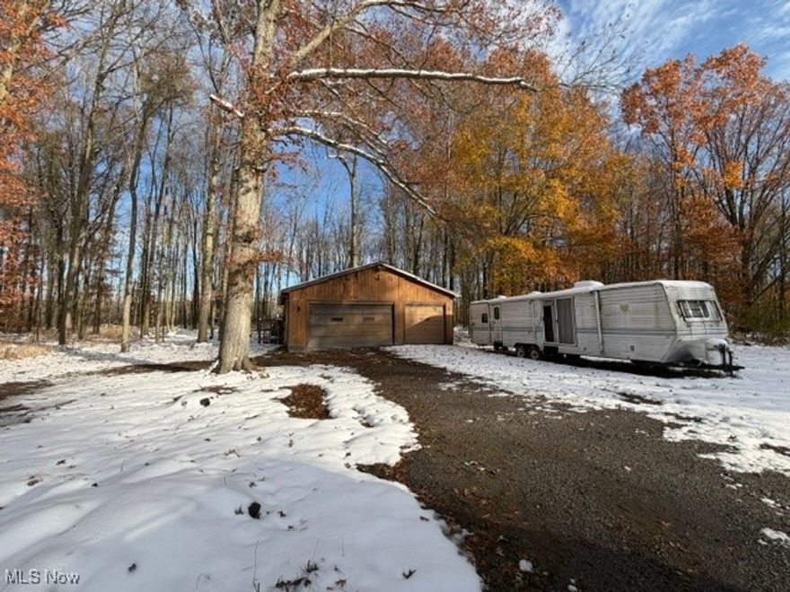 Looking for land in a great location? Look no further! Located in Champion OH, this 5.7 acres lot comes with a 32x48 ft insulated garage with an underground pedestal service with transformer having 220 ran to the garage on its own panel. Roof and gutters were replaced in the past 3 years.