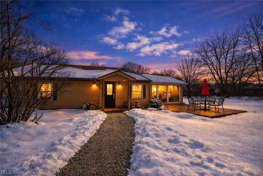 Nestled on a rare double lot (200x90) in the heart of the Portage Lakes area, this 1-bedroom, 1-bath ranch features open living spaces with bright, sun-filled rooms and flexible indoor-outdoor living options. To the right of the main living area is a 14x16 enclosed sunroom with glass windows on three sides. This versatile space is perfect for morning coffee, family gatherings, game nights, or relaxing while taking in the views. The sunroom opens onto a 12x16 front deck, creating a seamless indoor-outdoor space for entertaining or quiet evenings. The kitchen offers modern appliances and plenty of cabinet storage. The bedroom is bright with large windows, and the bathroom includes laundry. A large shed on the property provides extra storage, and the double lot offers room for outdoor activities and projects. Updates include: Water softener (2019), tankless water heater (2014), roof (2018), gutters (2021), well (2014), and well pump (2022) All appliances included: stainless steel microwave, stove, refrigerator, and washer/dryer unit. Act fast! Call your favorite agent today for a private showing and soon you'll make this Portage Lakes ranch your own for personal use or investment opportunities.