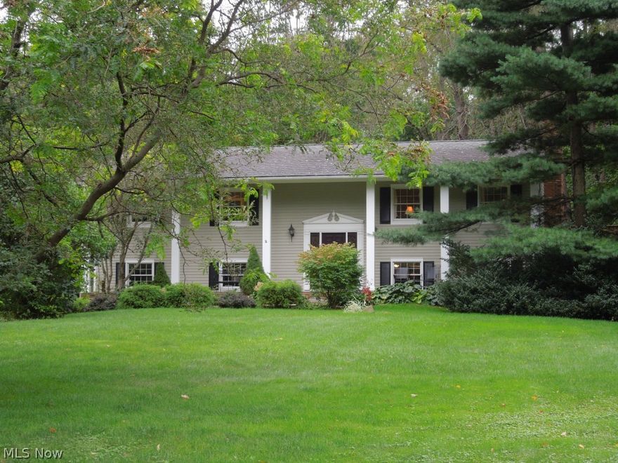 This one has it all!  Large private lot with gracious home! Beautifully maintained 4 bedroom home boasts hardwood floors and light filled rooms.  Brick fireplace with raised hearth adorns Great room and dining room.  Updated white eat-in kitchen looks out over wooded view.  Formal dining room with sliders.  Roomy bedrooms.  Both upstairs bathrooms updated in 2007.  Family room with fireplace.  Lower level Sun room has tons of light and open beamed ceiling.  Large deck overlooks private, wooded lot:  114 x 137 x 317 x 22 x 509. Convenient location.