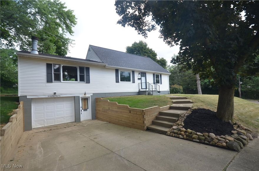 Incredible remodeled Ellet home with fantastic finished basement, a master suite w private full bathroom and unbelievable open layout with massive great room. This is a home you want to see in person to appreciate the wide open space that you just don't find in other Ellet homes. Enter to the living room with gorgeous original hardwood - it's a great flex space that could be used numerous different ways. The great room is sprawling and anchored by a gorgeous fireplace plus plenty of room to use as an eating area and an open view to the remodeled kitchen plus a new sliding glass door to access the back patio. New raised panel cabinets - including extra tall cabinets provide abundant storage space and beautiful finishes plus new counters and a breakfast bar. The first floor bedrooms are served by the remodeled full bathroom w granite counters, shower/tub and tile floor. Upstairs the master suite includes a loft sitting area a large bedroom w private full bathroom w shower/tub, a modern vanity and built in shelving. The lower level includes a fantastic rec room for additional living space plus unfinished area for laundry, utilities and storage. Updates include: '24 Roof, Gutters, Electrical Panel, PEX Plumbing throughout, large amount of home re-wired. '25: Kitchen, Both Bathrooms, Interior Doors and Front Door, Sliding Glass Door, Basement windows & Window Wells, Great Rm picture window plus one to right, front room picture window, front window of front bedroom. The oversized 1 car attached garage provides convenient access and a lot of space (22x19) with electric and opener.